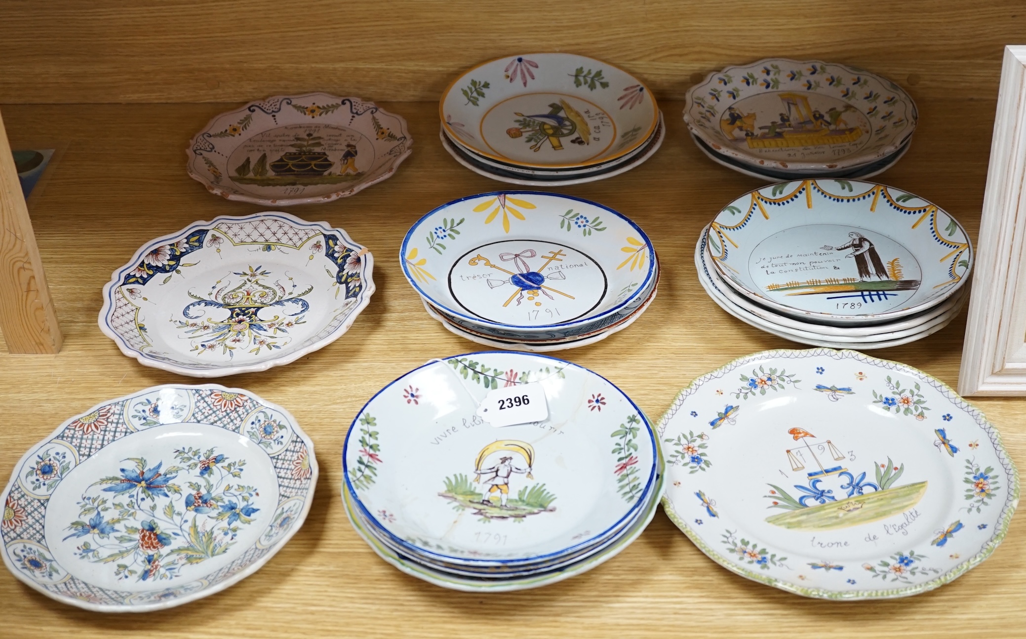 A collection of twenty 18th/19th century French faience polychrome and blue and white Revolution commemorative plates and three others, largest 27cm diameter (23). Condition - condition varies poor to good